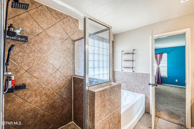 401 Everlook Ln, Horizon City, TX 79928 - full bath with a bath, a stall shower, tile walls, and a textured ceiling