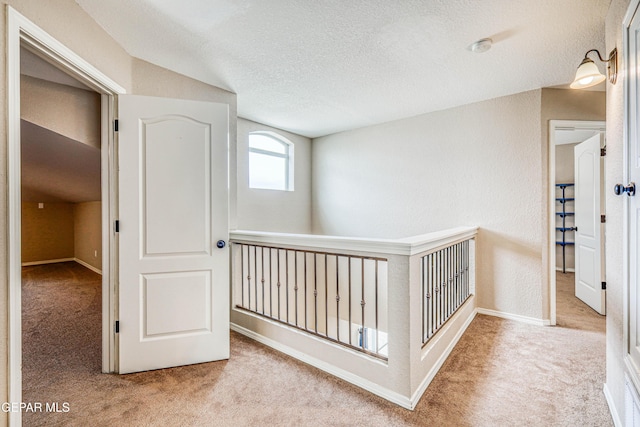 401 Everlook Ln, Horizon City, TX 79928 - hallway featuring carpet floors and a textured ceiling