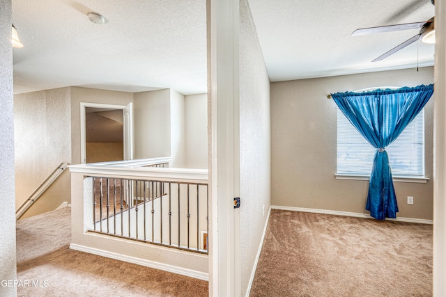 401 Everlook Ln, Horizon City, TX 79928 - hall featuring carpet floors, an upstairs landing, a textured ceiling, and a textured wall