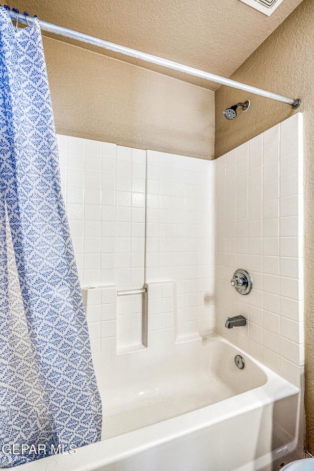 401 Everlook Ln, Horizon City, TX 79928 - full bath with a textured wall, shower / bathtub combination with curtain, and a textured ceiling