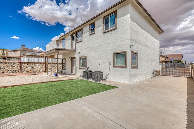 401 Everlook Ln, Horizon City, TX 79928 - back of house featuring a balcony, a patio, a fenced backyard, and stucco siding