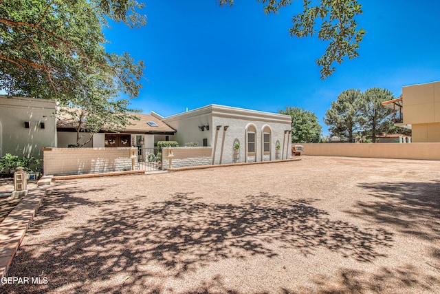 5430 Davis Cup Ct, El Paso, TX 79932 - rear view of property featuring a fenced front yard, stucco siding, and a gate
