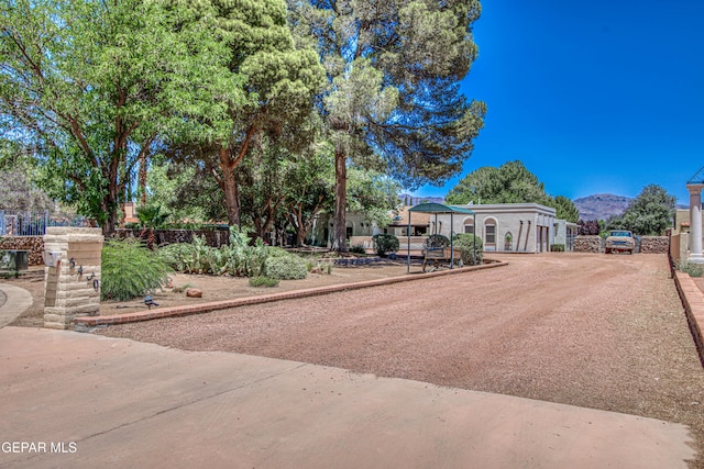 5430 Davis Cup Ct, El Paso, TX 79932 - view of yard with a mountain view and driveway