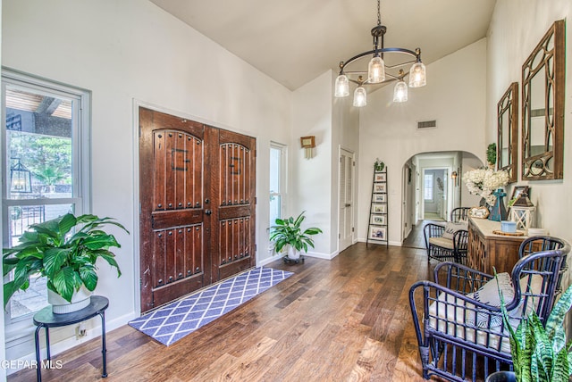 5430 Davis Cup Ct, El Paso, TX 79932 - entryway featuring high vaulted ceiling, wood finished floors, arched walkways, and a chandelier
