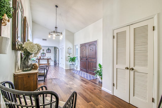 5430 Davis Cup Ct, El Paso, TX 79932 - entryway featuring high vaulted ceiling, a chandelier, and wood finished floors
