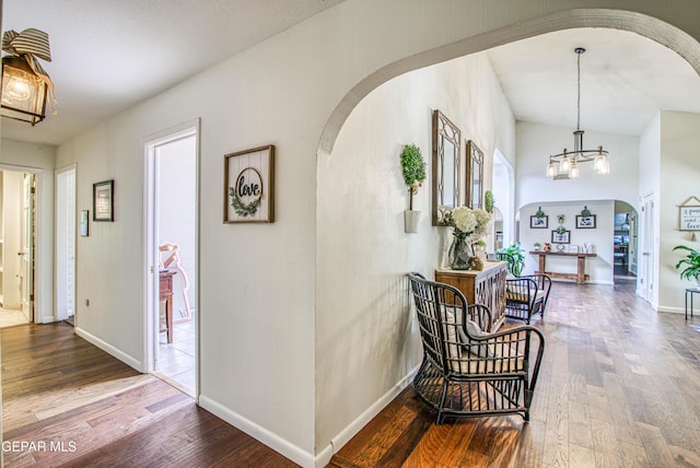 5430 Davis Cup Ct, El Paso, TX 79932 - corridor featuring arched walkways, wood finished floors, and a chandelier