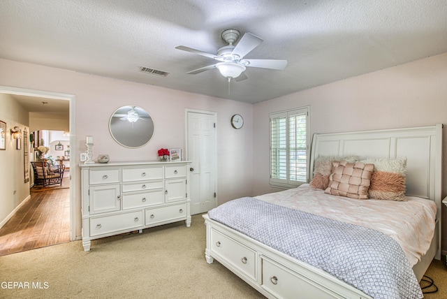 5430 Davis Cup Ct, El Paso, TX 79932 - bedroom with light carpet, a textured ceiling, and a ceiling fan