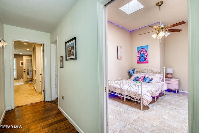 5430 Davis Cup Ct, El Paso, TX 79932 - bedroom featuring a skylight, wood finished floors, and ceiling fan