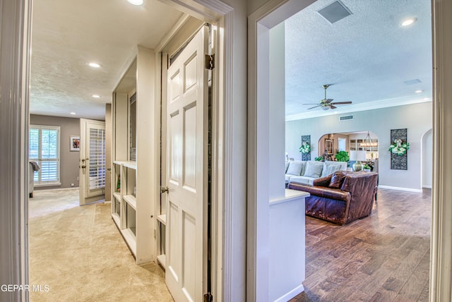 5430 Davis Cup Ct, El Paso, TX 79932 - hall with recessed lighting, a textured ceiling, ornamental molding, light wood-style flooring, and arched walkways
