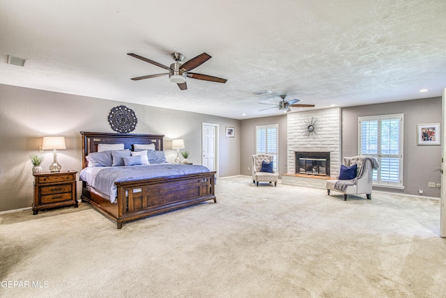 5430 Davis Cup Ct, El Paso, TX 79932 - carpeted bedroom with a fireplace, multiple windows, a textured ceiling, recessed lighting, and ceiling fan