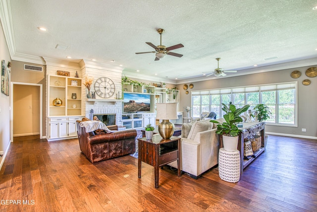 5430 Davis Cup Ct, El Paso, TX 79932 - living area featuring a textured ceiling, ceiling fan, dark wood-type flooring, a brick fireplace, and recessed lighting