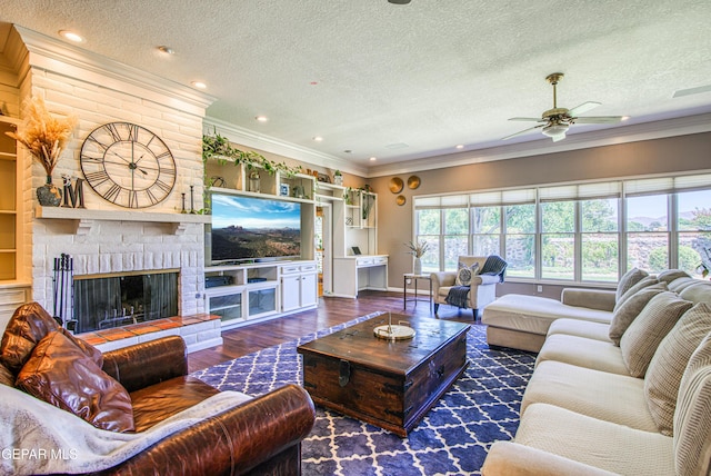 5430 Davis Cup Ct, El Paso, TX 79932 - living area featuring a textured ceiling, a ceiling fan, wood finished floors, a brick fireplace, and crown molding
