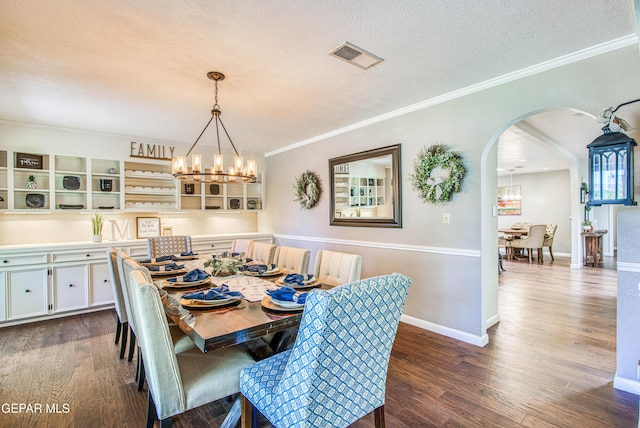 5430 Davis Cup Ct, El Paso, TX 79932 - dining room with arched walkways, a chandelier, dark wood-style flooring, ornamental molding, and a textured ceiling