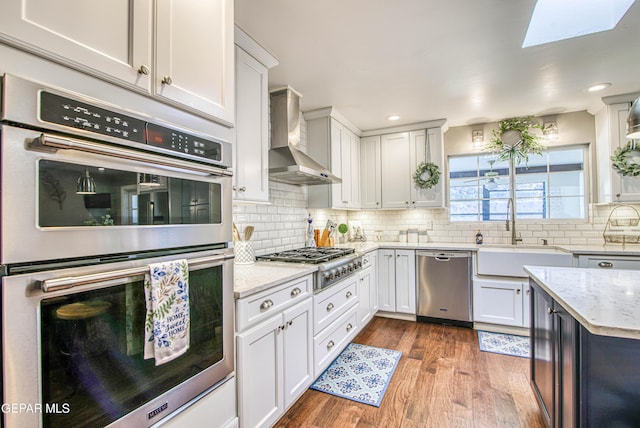 5430 Davis Cup Ct, El Paso, TX 79932 - kitchen with stainless steel appliances, wood finished floors, light stone countertops, white cabinetry, and recessed lighting