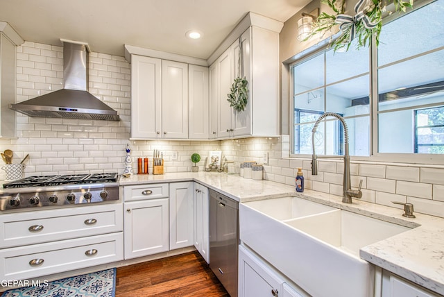 5430 Davis Cup Ct, El Paso, TX 79932 - kitchen featuring wall chimney range hood, stainless steel appliances, white cabinets, backsplash, and recessed lighting