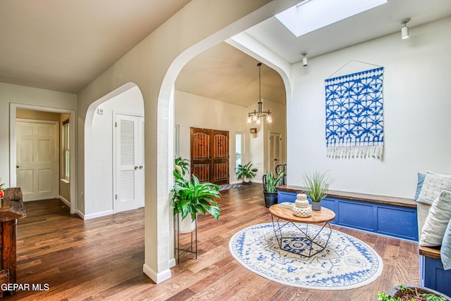 5430 Davis Cup Ct, El Paso, TX 79932 - foyer with a skylight, arched walkways, wood finished floors, and a chandelier