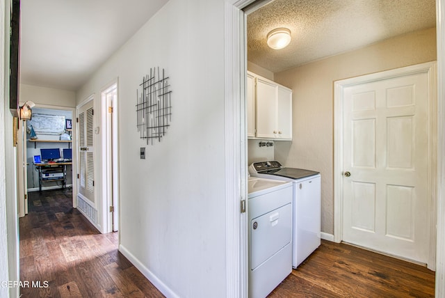 5430 Davis Cup Ct, El Paso, TX 79932 - washroom featuring washing machine and clothes dryer, cabinet space, dark wood-type flooring, and a desk