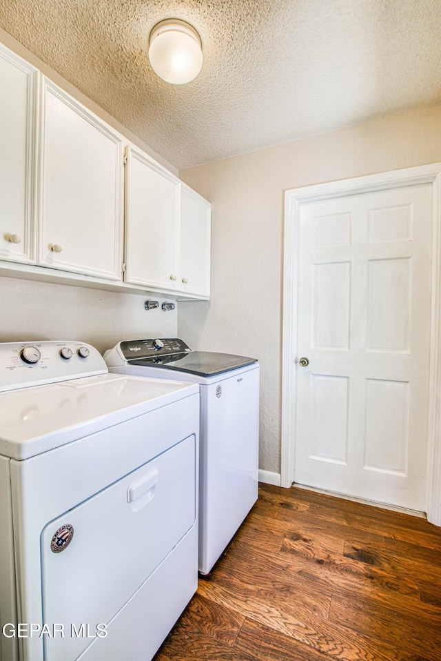 5430 Davis Cup Ct, El Paso, TX 79932 - laundry room featuring separate washer and dryer, cabinet space, dark wood finished floors, and a textured ceiling