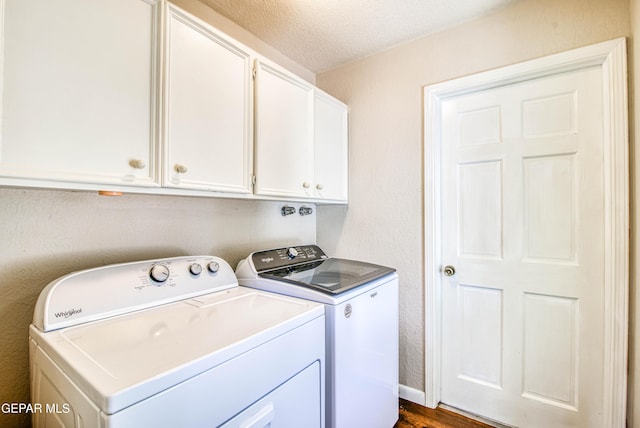 5430 Davis Cup Ct, El Paso, TX 79932 - laundry area with washer and clothes dryer, cabinet space, a textured ceiling, and dark wood-style flooring