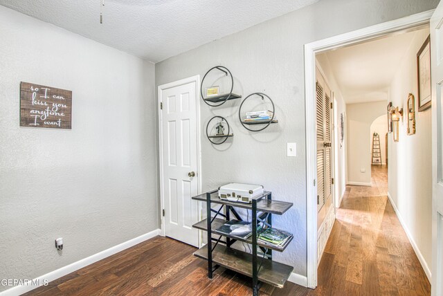5430 Davis Cup Ct, El Paso, TX 79932 - corridor featuring wood finished floors, arched walkways, and a textured ceiling