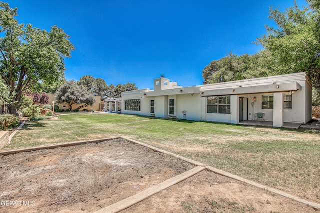 5430 Davis Cup Ct, El Paso, TX 79932 - back of house featuring stucco siding, a yard, and a chimney