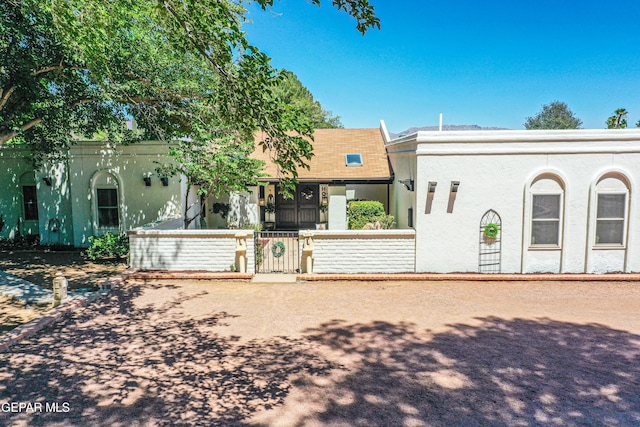 5430 Davis Cup Ct, El Paso, TX 79932 - view of front of property featuring a fenced front yard, stucco siding, and a gate
