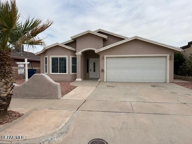 9728 El Tepeyac Ave, El Paso, TX 79927 - ranch-style house with stucco siding, a garage, and concrete driveway