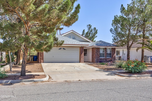 11969 Oak Abbey Ct, El Paso, TX 79936 - view of front of house featuring an attached garage, driveway, and brick siding