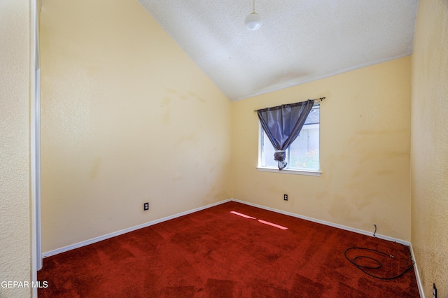 11969 Oak Abbey Ct, El Paso, TX 79936 - empty room with dark carpet, lofted ceiling, and a textured ceiling