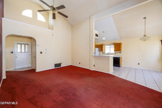 11969 Oak Abbey Ct, El Paso, TX 79936 - unfurnished living room with ceiling fan, high vaulted ceiling, light colored carpet, arched walkways, and light tile patterned flooring
