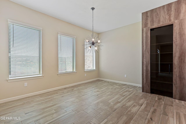 14904 John Mcneely Ave, El Paso, TX 79938 - spare room with a chandelier and light wood-style flooring
