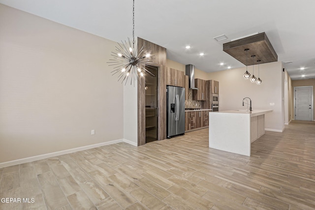 14904 John Mcneely Ave, El Paso, TX 79938 - kitchen with stainless steel appliances, light countertops, modern cabinets, brown cabinets, and light wood finished floors