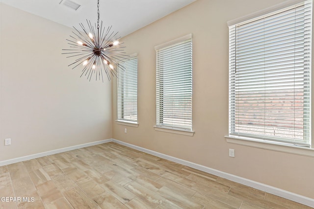 14904 John Mcneely Ave, El Paso, TX 79938 - spare room featuring a chandelier and light wood-style flooring