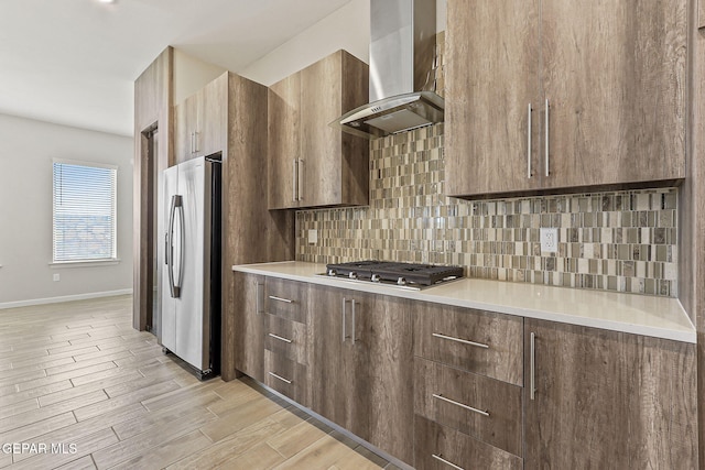 14904 John Mcneely Ave, El Paso, TX 79938 - kitchen featuring range hood, appliances with stainless steel finishes, decorative backsplash, and light countertops