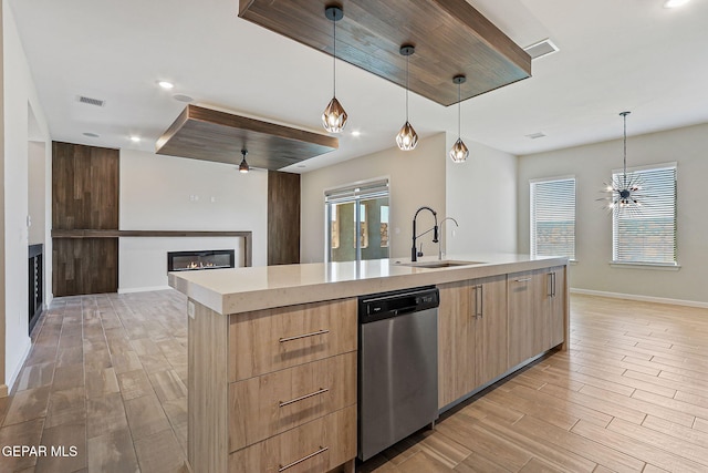 14904 John Mcneely Ave, El Paso, TX 79938 - kitchen with dishwasher, a glass covered fireplace, light brown cabinets, modern cabinets, and recessed lighting