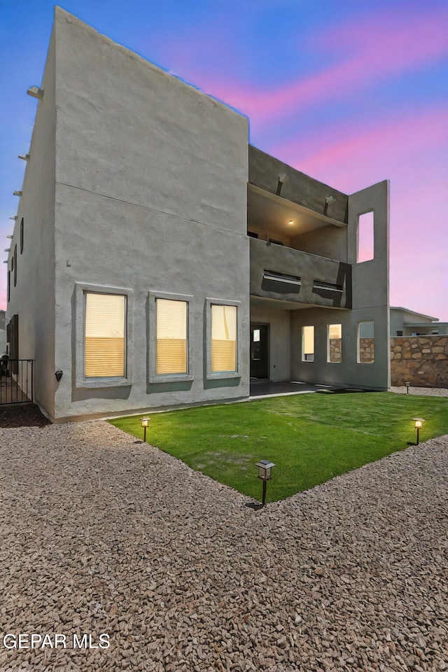 14904 John Mcneely Ave, El Paso, TX 79938 - back of house at dusk featuring a patio area and a balcony