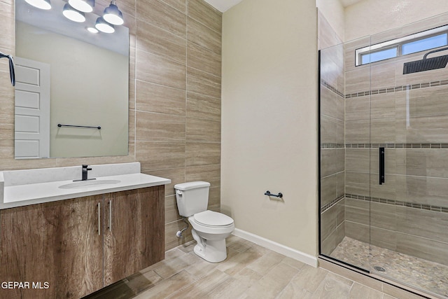 14904 John Mcneely Ave, El Paso, TX 79938 - bathroom with tile walls, a stall shower, and vanity