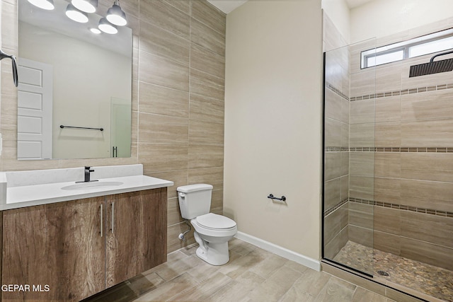 14904 John Mcneely Ave, El Paso, TX 79938 - bathroom featuring tiled shower, tile walls, and vanity