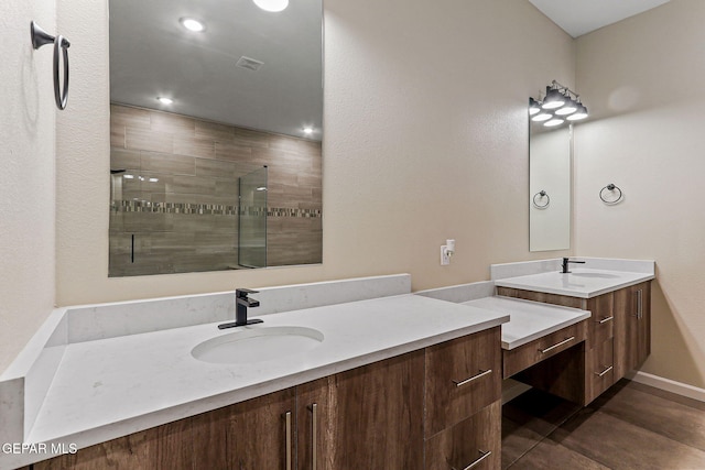 14904 John Mcneely Ave, El Paso, TX 79938 - full bath featuring two vanities, a tile shower, and recessed lighting