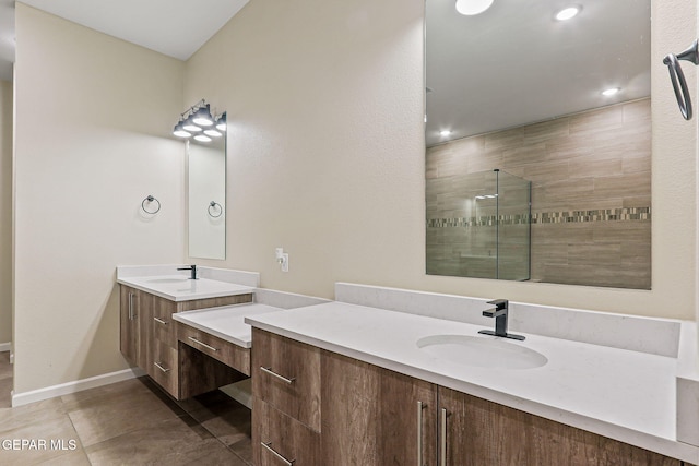 14904 John Mcneely Ave, El Paso, TX 79938 - bathroom with two vanities, tiled shower, recessed lighting, and tile patterned floors