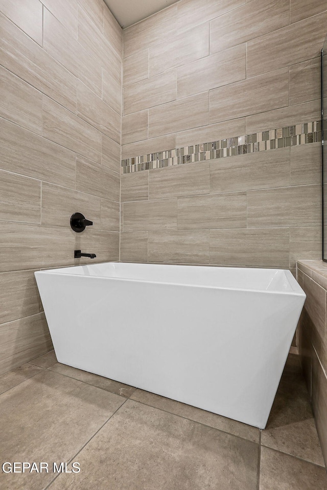 14904 John Mcneely Ave, El Paso, TX 79938 - full bath with a soaking tub, tile patterned floors, and tile walls