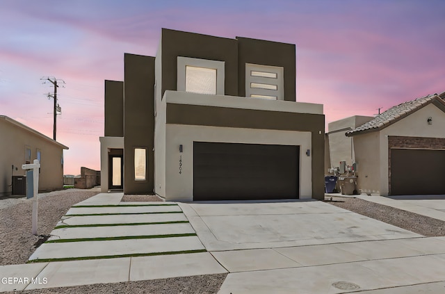 14904 John Mcneely Ave, El Paso, TX 79938 - contemporary house featuring stucco siding, concrete driveway, and a garage