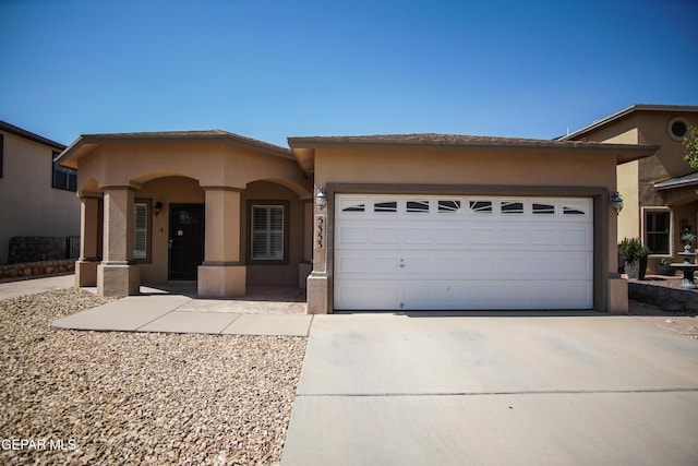 5353 Manuel Puentes Ct, El Paso, TX 79934 - view of front of property featuring an attached garage, driveway, and stucco siding