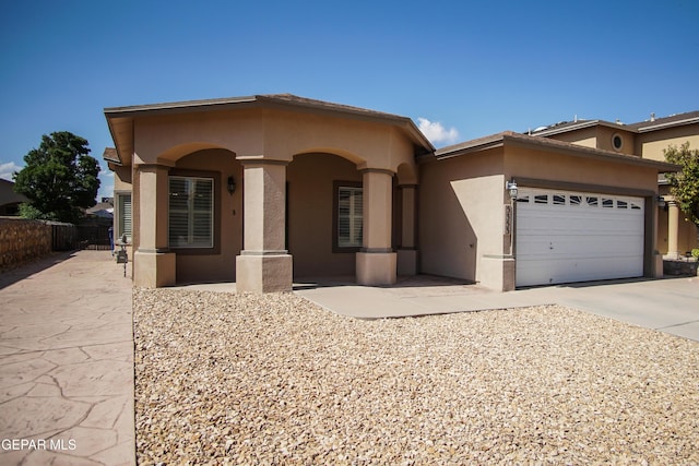 5353 Manuel Puentes Ct, El Paso, TX 79934 - mediterranean / spanish-style home with stucco siding, a garage, and driveway
