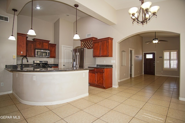 5353 Manuel Puentes Ct, El Paso, TX 79934 - kitchen featuring appliances with stainless steel finishes, high vaulted ceiling, arched walkways, ceiling fan, and a peninsula