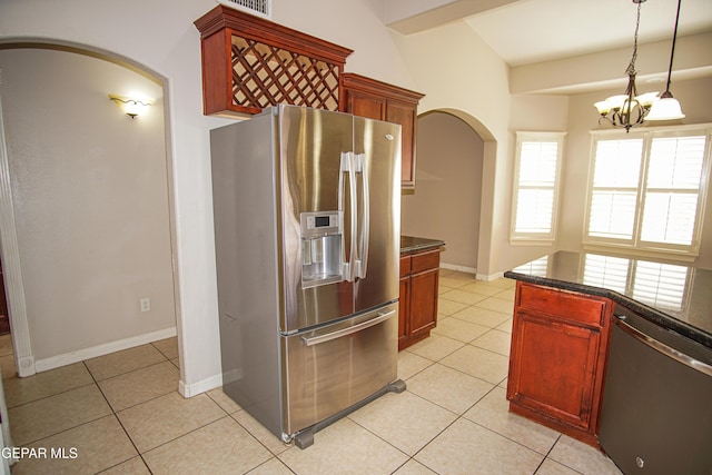 5353 Manuel Puentes Ct, El Paso, TX 79934 - kitchen featuring stainless steel appliances, arched walkways, light tile patterned flooring, and dark brown cabinets