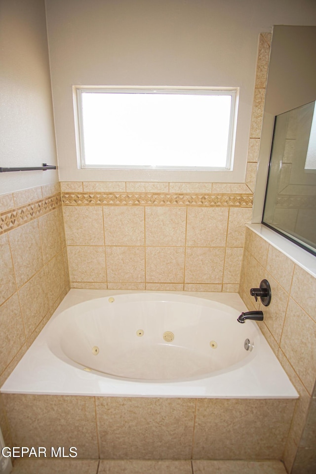 5353 Manuel Puentes Ct, El Paso, TX 79934 - full bath with plenty of natural light and a tub with jets