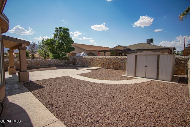 5353 Manuel Puentes Ct, El Paso, TX 79934 - fenced backyard with a shed and a patio area