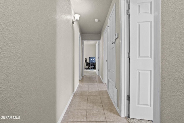 14215 Otter Point Ct, El Paso, TX 79938 - hallway with a textured wall and light tile patterned floors
