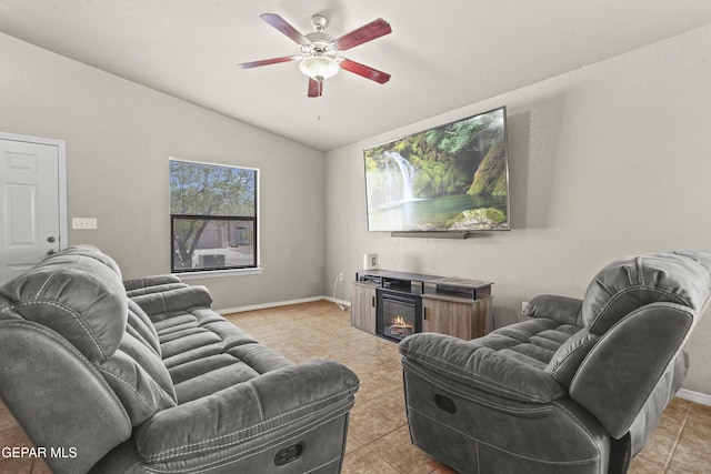 14215 Otter Point Ct, El Paso, TX 79938 - living area with vaulted ceiling, a ceiling fan, light tile patterned floors, and a glass covered fireplace